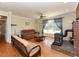 Comfortable living room featuring hardwood floors, fireplace, and natural light at 2371 Nc 210, Smithfield, NC 27577