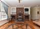 Unique living room showcasing a brick fireplace, custom woodwork, and ample lighting at 2371 Nc 210, Smithfield, NC 27577