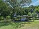 View of the property featuring an outbuilding with a small storage area and covered shelter at 2371 Nc 210, Smithfield, NC 27577