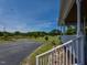 Inviting porch with white railings overlooks a pond, offering a serene view of the lush yard at 2371 Nc 210, Smithfield, NC 27577