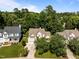 Aerial view of a suburban home surrounded by lush green trees in a quiet neighborhood at 2412 Colony Woods Dr, Apex, NC 27523