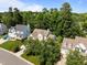 An elevated view of a well-maintained property surrounded by lush trees and landscaping at 2412 Colony Woods Dr, Apex, NC 27523
