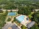 Aerial view of community amenities, including a pool, tennis courts, and green spaces at 2412 Colony Woods Dr, Apex, NC 27523