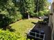 Aerial view of the backyard showing the deck, grill, firepit, seating, and lawn at 2412 Colony Woods Dr, Apex, NC 27523