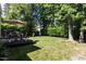 Lush backyard offers a large deck, inviting seating, and expansive lawn for outdoor activities at 2412 Colony Woods Dr, Apex, NC 27523