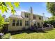 Exterior shot of the home from the backyard, highlighting the deck and spacious yard at 2412 Colony Woods Dr, Apex, NC 27523