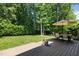 Landscaped backyard features a spacious deck, fire pit, and ample seating for outdoor enjoyment at 2412 Colony Woods Dr, Apex, NC 27523
