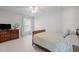 Bright, minimalist bedroom featuring neutral tones, a queen-sized bed, and modern furnishings for a clean, serene space at 2412 Colony Woods Dr, Apex, NC 27523