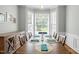 Well-lit dining room featuring a large window, hardwood floors, and classic furnishings at 2412 Colony Woods Dr, Apex, NC 27523