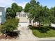 Charming home exterior with lush landscaping, a paved driveway, and a welcoming entrance at 2412 Colony Woods Dr, Apex, NC 27523