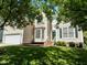 Traditional home featuring green door and shutters with bay window and a lush lawn at 2412 Colony Woods Dr, Apex, NC 27523