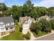 Lovely two-story home featuring manicured lawn, attached garage, and mature trees on a sunny day at 2412 Colony Woods Dr, Apex, NC 27523