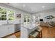 Open kitchen with granite island, stainless steel appliances, and a view of the living room at 2412 Colony Woods Dr, Apex, NC 27523