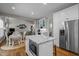Spacious kitchen featuring an island with microwave, stainless steel appliances, and open floor plan at 2412 Colony Woods Dr, Apex, NC 27523