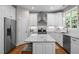 Bright kitchen with white cabinets, granite countertops, stainless steel appliances, and a large island at 2412 Colony Woods Dr, Apex, NC 27523