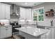Bright kitchen featuring a granite island, modern appliances, and decorative tile backsplash at 2412 Colony Woods Dr, Apex, NC 27523