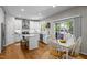Well-lit kitchen with white cabinets, granite countertops, stainless steel appliances, and a breakfast area at 2412 Colony Woods Dr, Apex, NC 27523