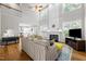 Bright living room with fireplace, high ceilings, hardwood floors, and seamless access to the kitchen at 2412 Colony Woods Dr, Apex, NC 27523