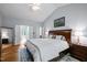 Large main bedroom featuring vaulted ceiling, ensuite bathroom, and wooden furniture at 2412 Colony Woods Dr, Apex, NC 27523