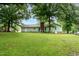 Spacious backyard features a lush lawn with a garden area in a well-maintained landscape at 2532 Rolling Meadows Dr, Raleigh, NC 27603