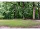 Expansive backyard with mature trees, offering a serene and private outdoor space at 2532 Rolling Meadows Dr, Raleigh, NC 27603
