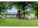 Expansive backyard featuring a well-maintained lawn, mature trees, and a charming patio at 2532 Rolling Meadows Dr, Raleigh, NC 27603