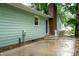View of backyard patio with brick chimney and exterior entrance door at 2532 Rolling Meadows Dr, Raleigh, NC 27603