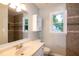 Updated bathroom features tile accents, updated vanity, and a window with green tree view at 2532 Rolling Meadows Dr, Raleigh, NC 27603