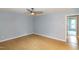 This bedroom has light-blue walls, light-color hardwood floors, and a ceiling fan at 2532 Rolling Meadows Dr, Raleigh, NC 27603
