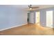 This bedroom has light-blue walls, light-color hardwood floors, and a ceiling fan at 2532 Rolling Meadows Dr, Raleigh, NC 27603