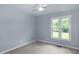 Bedroom with plush carpeting, ceiling fan, and large window bringing in natural light at 2532 Rolling Meadows Dr, Raleigh, NC 27603