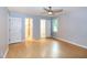Large bedroom with hardwood flooring, ceiling fan, and multiple entrances at 2532 Rolling Meadows Dr, Raleigh, NC 27603