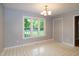 Sunlit dining room with view to outdoors, neutral wall paint, and closet space at 2532 Rolling Meadows Dr, Raleigh, NC 27603