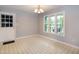 Bright dining room featuring classic chandelier, large windows, and neutral wall paint at 2532 Rolling Meadows Dr, Raleigh, NC 27603