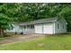 Single-story home with blue shutters, an attached two-car garage, and a white picket fence at 2532 Rolling Meadows Dr, Raleigh, NC 27603