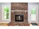 Close-up of a brick fireplace with white mantel in a spacious living area at 2532 Rolling Meadows Dr, Raleigh, NC 27603