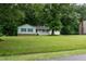 Charming home nestled on a lush lot with a well-manicured lawn and inviting curb appeal at 2532 Rolling Meadows Dr, Raleigh, NC 27603