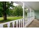 Inviting porch with white railing showcasing lush greenery and neighborhood views at 2532 Rolling Meadows Dr, Raleigh, NC 27603