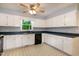 Bright kitchen with a ceiling fan, white cabinets and black appliances at 2532 Rolling Meadows Dr, Raleigh, NC 27603