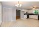 Open kitchen featuring white cabinets, contrasting countertops and flooring, with adjoining dining area at 2532 Rolling Meadows Dr, Raleigh, NC 27603