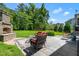 Beautiful patio with an outdoor fireplace and comfortable seating, perfect for relaxing and entertaining at 2538 Tuffeto, Apex, NC 27502