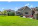 Spacious backyard with patio, stone fireplace, and manicured lawn at 2538 Tuffeto, Apex, NC 27502