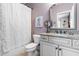 Bathroom featuring a vanity with granite counters, patterned shower curtain, and tiled floors at 2538 Tuffeto, Apex, NC 27502