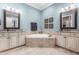 Beautiful bathroom featuring a soaking tub, double vanity, granite counters, and light blue walls at 2538 Tuffeto, Apex, NC 27502