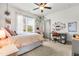 Bright bedroom featuring a ceiling fan, comfortable bed, and light-filled window at 2538 Tuffeto, Apex, NC 27502