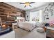 Cozy bedroom featuring a wooden accent wall, comfortable bed, and bright window at 2538 Tuffeto, Apex, NC 27502