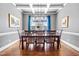 Elegant dining room with coffered ceilings, stylish chandelier, and ample seating for formal gatherings at 2538 Tuffeto, Apex, NC 27502
