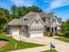 Beautiful home with a three-car garage, a basketball hoop, well-manicured lawn, and attractive landscaping at 2538 Tuffeto, Apex, NC 27502