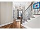 Entryway with hardwood floors, staircase and stained-glass window with exterior view at 2538 Tuffeto, Apex, NC 27502