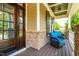 Charming front porch with stone accents and comfortable seating, perfect for relaxation and enjoying the outdoors at 2538 Tuffeto, Apex, NC 27502